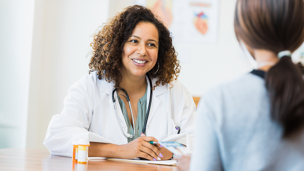 Doctor talking with a patient about dermatomyositis treatment options