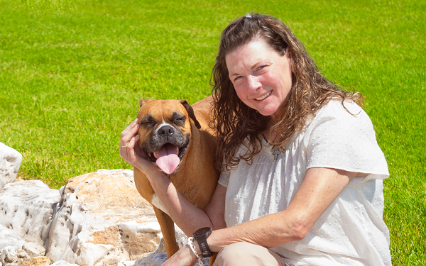 See the VALOR Study Results Tamara, a real patient taking LISRAYA for dermatomyositis, sitting outdoors with her dog